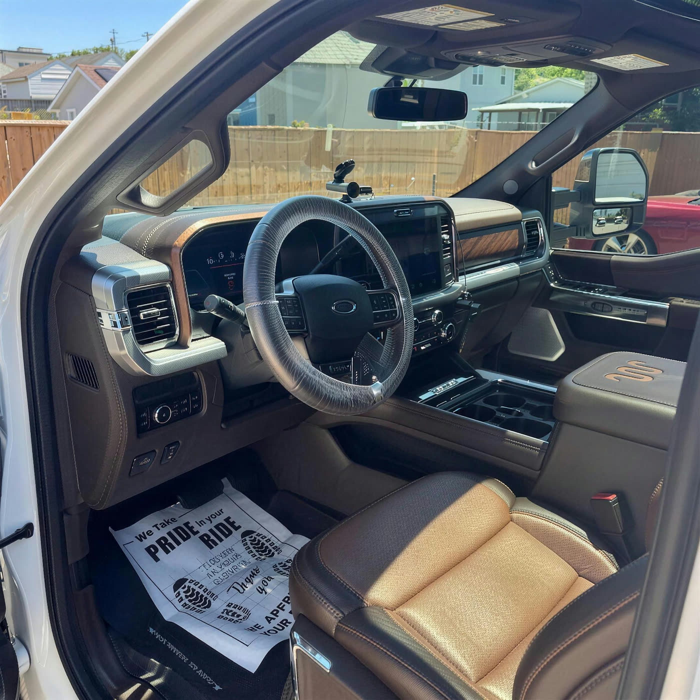 Ford F-250 Super Duty King Ranch cab with conditioned brown leather seats and a Key City Details floor protector