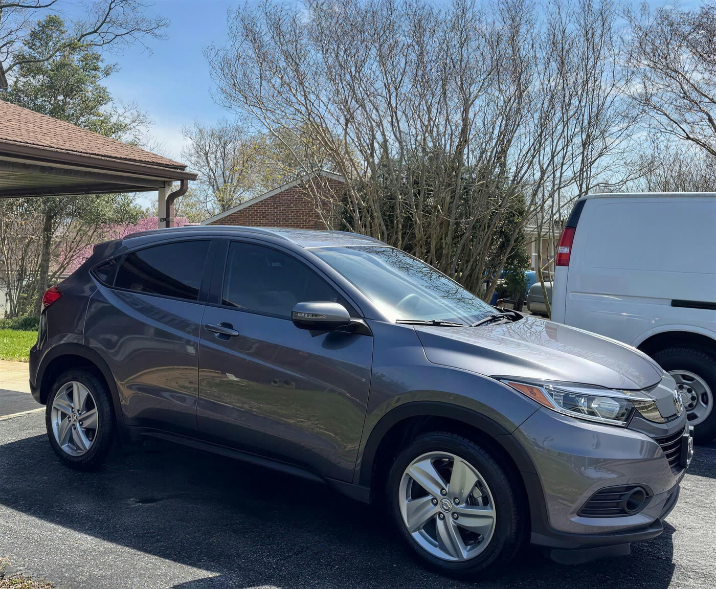 Grey Honda HR-V detailed on a residential driveway with the Key City Details van parked behind it