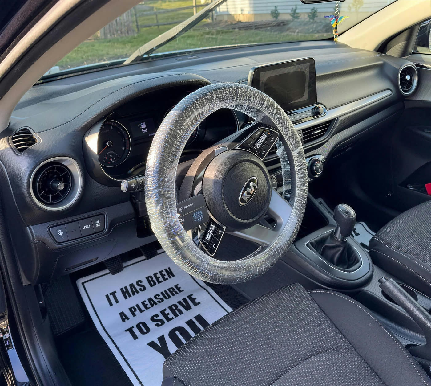 Cleaned Kia Forte interior with a protective steering wheel cover fitted
